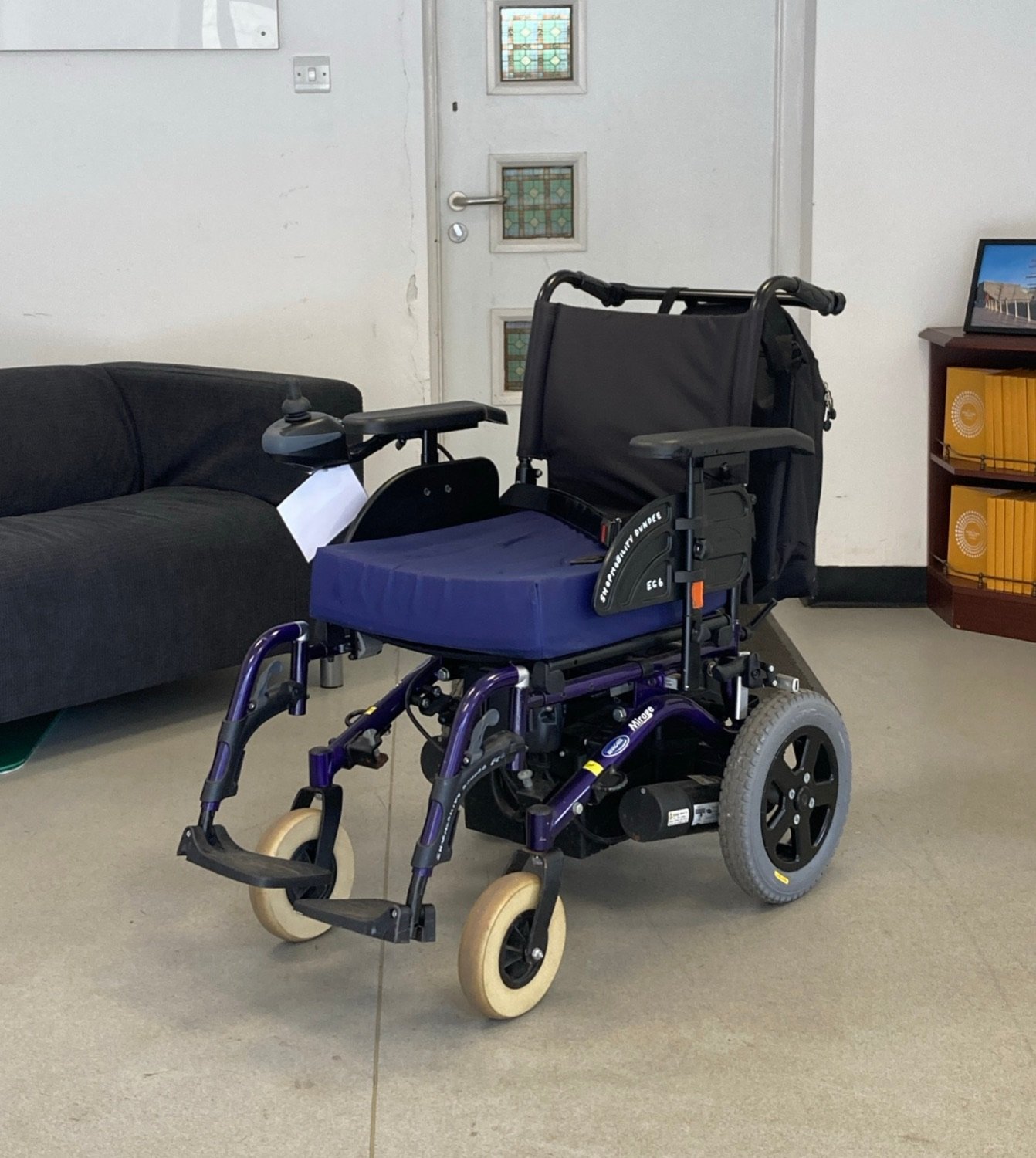 An electric wheelchair, one model of which separates into four parts for a car boot