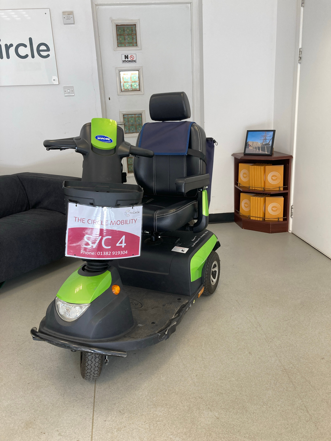 An Orion Metro three-wheel scooter, black with lime green detailing