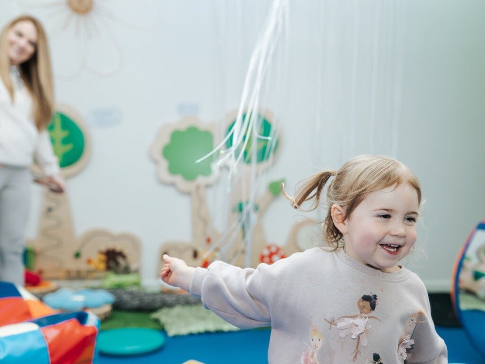 The Circle CIC More Than Profit social enterprise Social Impact Report 2021/22. The image shows a child playing in the sensory hub in the circle Glasgow.