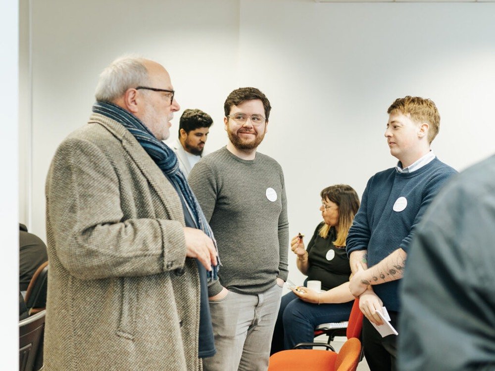 A group of men chatting at a networking event at The Circle Glasgow