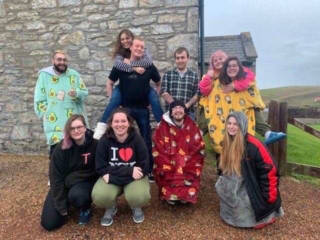 The Shetland Project OPEN who have won The Circle Academy Pitch Contest 2022 take a group picture of 10 young people in their jammies.